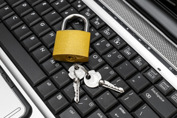 Padlock with keys on laptop keyboard.