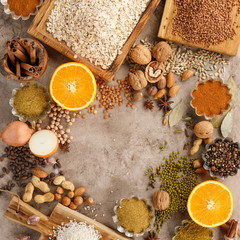 Dried fruits cereals spices and nuts organic healthy snacks on a textural background. The concept of healthy eating. Lenten products. Frame under the text. Copy space.