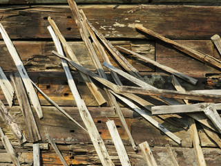 A wall of railway sleepers with boards nailed