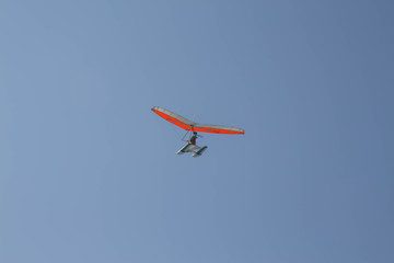Fototapeta na wymiar Delta wing with engine flies by the blue sky
