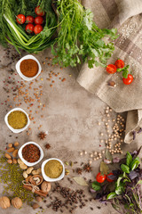 Fresh greens and tomatoes cereals spices and nuts organic healthy snacks on a textural background. The concept of healthy eating. Lean foods. Copy space.