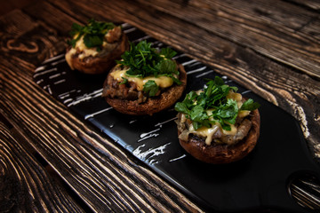 Stuffed mushrooms on a rough wooden surface