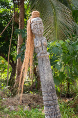 Ancient wooden statue in jungle. Old religious totem. Shaman column in temple, Asia. Traditional...