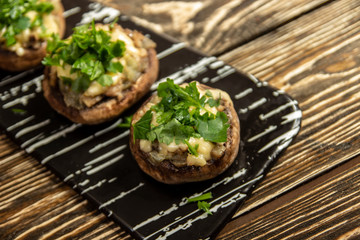 Stuffed mushrooms on a rough wooden surface
