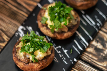 Stuffed mushrooms on a rough wooden surface