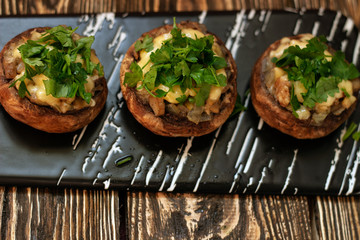 Stuffed mushrooms on a rough wooden surface