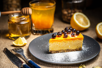 Cheesecake slice on a blue plate. Sugar snow. Sugar snow.