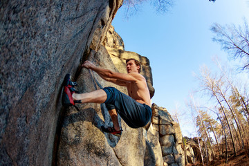 rock shoe close-up of a rock climber climbs a boulder over a rock without insurance