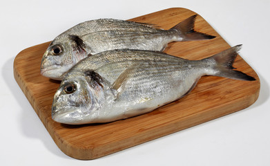 Fresh dorado fish on wooden cutting board