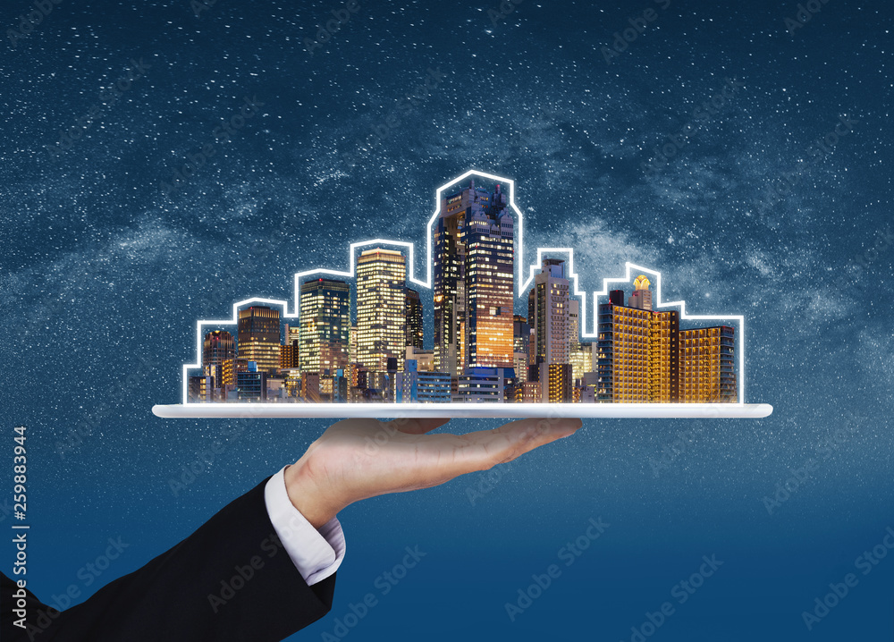 Canvas Prints Real estate business, building technology and smart city. Businessman hand holding digital tablet with buildings hologram