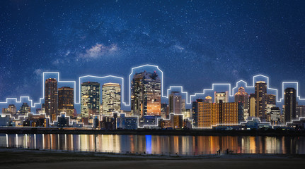 Smart city and smart building technology. Buildings in the city at night with starry sky in Osaka,...