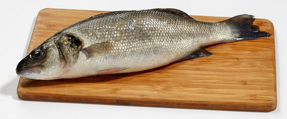 Fresh perch fish on wooden cutting board