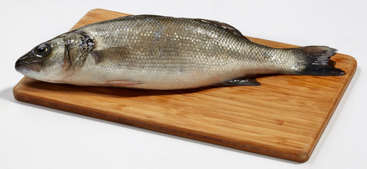 Fresh perch fish on wooden cutting board