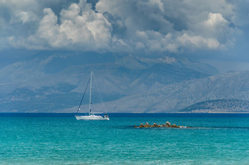 Fototapeta premium Corfu, Panorama to the mountain peaks in Albania, sailing yacht on the sea.