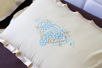 colorful embroidery design on a white pillow