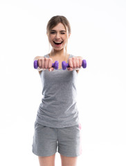 Naklejka premium Portrait of pretty sporty girl holding weights dumbbells and make exercises on white background.