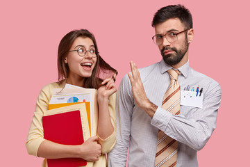 Serious male tutor has lesson with trainee who flirts and expresses symathy, shows stop gesture,...