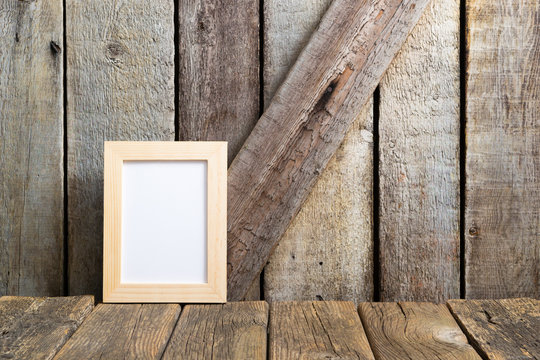 picture frame blank paper at rustic wooden interior