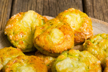 homemade baked scone cakes from fresh ramson leaves and cheese, old wooden texture