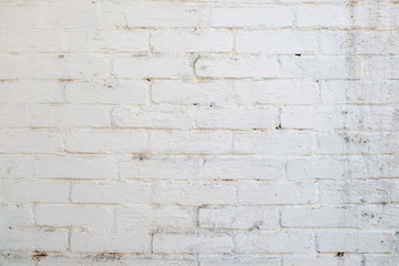 white wall, the rough brickwork of the wall.