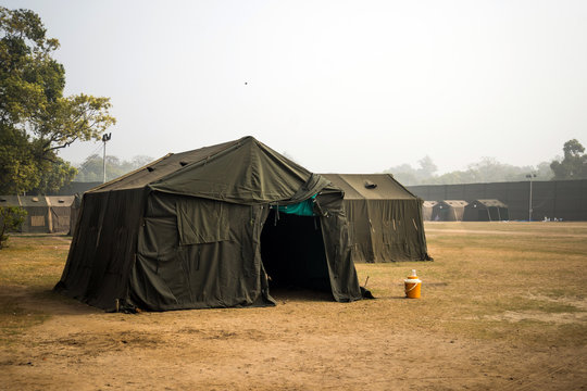 Military tent in the field. big tent city. field camp in nature. military base with temporary barracks. military exercises of the soldiers. large military tent. Army camp. reconstruction warfare.
