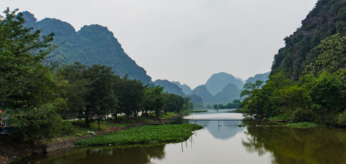 Fototapeta na wymiar river and limestone mountains in Hoa Lu, ancient capital of Vietnam