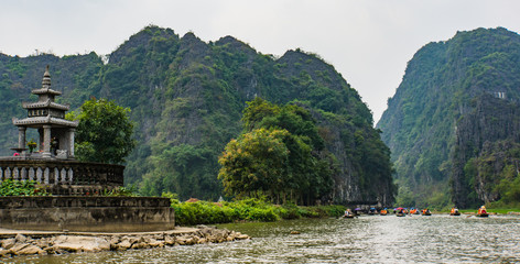 tourist  trip along the Tam Coc river between the limestone mountains in Ninh Binh area, Vietnam