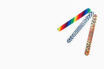 Obraz premium Multicolored used pedicure manicure nail files on white isolated background