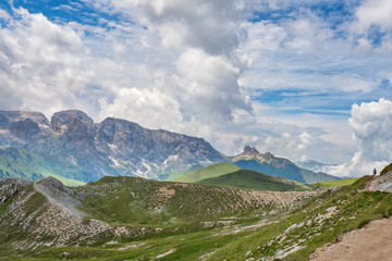 Beautiful view of mountainous alp landscape in the Dolomites with a hiker