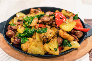 Freshly tasty cooked one pot sausage and vegetables served in frying pan