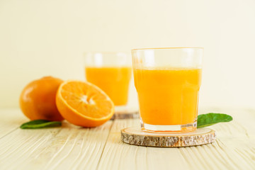 Fresh orange juice on wood background