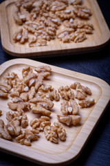 Walnuts on the wooden plate on the table