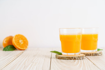 Fresh orange juice on wood background