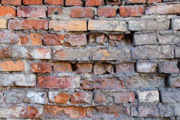 Uneven, sloppy brickwork of an old brick wall.