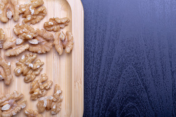 Walnuts on the wooden plate on the table