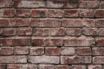 Old brick wall in white paint. Retro pattern of red bricks. Brown brick wall in whitewash. Vintage house facade. Red brown brick wall texture grunge background.
