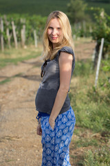 young pregnant woman posing in nature