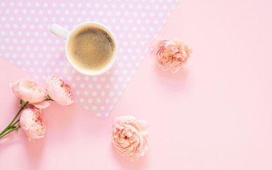 Composition of white cup with black coffee and flowers on a light pink background. Morning concept. Flat Lay. Top View