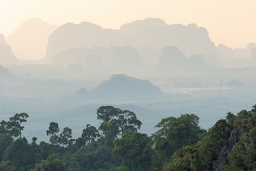 Landscape view on silhouettes of tropical hazy mountains perspective and the green jungle trees