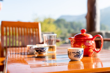 tea pot and cup on the table with morning sunlight