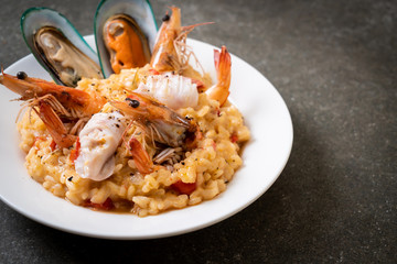 risotto with seafoods (shrimps, mussels, octopus, clams) and tomatoes
