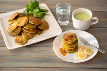 Dietary pancakes with spinach. Stack of pancakes