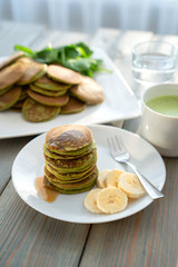 Dietary pancakes with spinach. Stack of pancakes