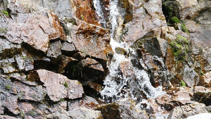 Waterfall among stones and rocks