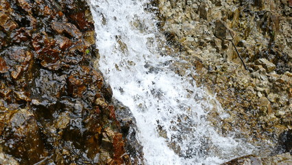 Waterfall among stones and rocks