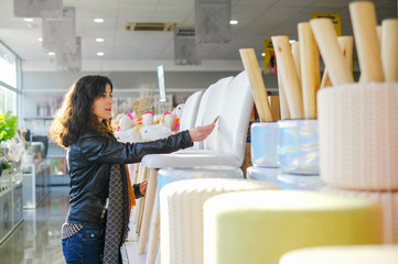 Woman buying furnitures in shop, selecting products