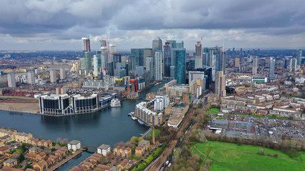 Fototapeta na wymiar Aerial drone shot from iconic Canary Wharf skyscraper business and financial area with lots of clouds, Docklands, Isle of Dogs, London, United Kingdom