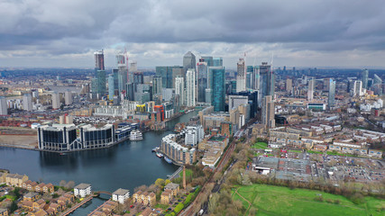 Fototapeta na wymiar Aerial drone shot from iconic Canary Wharf skyscraper business and financial area with lots of clouds, Docklands, Isle of Dogs, London, United Kingdom