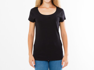 Cropped portrait of young blond woman with beautiful slim body wearing black T-shirt with copy space for your text or advertising content. Close up of fashionable teenager trying on new clothing