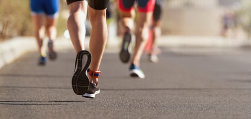 Fototapeta premium Marathon running race, people feet on city road
